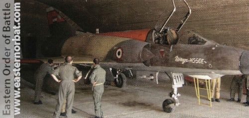 French and Egyptian ground crews inspect Egyptian Air Force Mirage 5SDE 9111 in a shelter at an unknown Air Base before a mission.