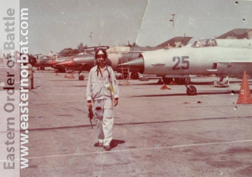 Foreign pilot in 322nd Training Air Regiment in Kant airbase in front of grey MiG-21bis, and other colorfull camouflage MiG-21s in the eighties.
